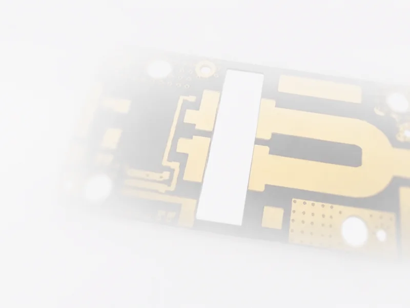 High-frequency RF microwave PCB layout showing gold microstrip traces and via array for signal integrity.