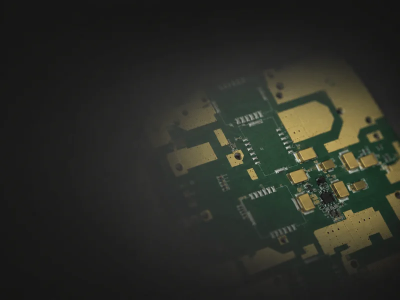 Abstraction of an RF microwave PCB with a soft-focus blur highlighting microstrip traces.